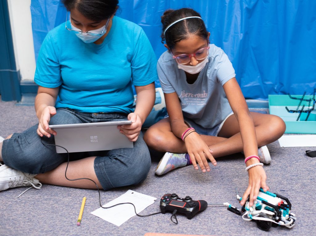 girls programming their Mars exploration robot using a computer donated by the Domenica Foundation