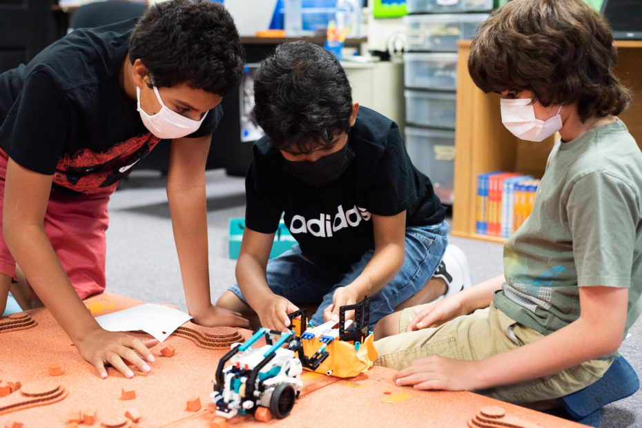 Boys troubleshooting their Mars exploration robot