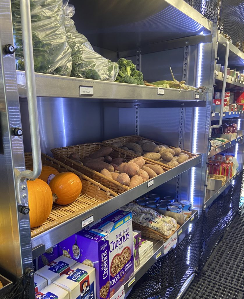 interior of Virtua mobile grocery with rows of veg and fruit