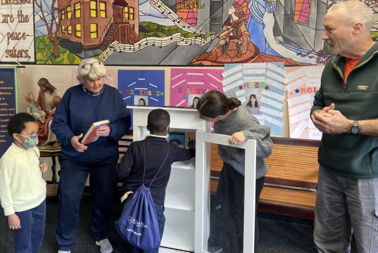 photo of St. Cecilia children placing books in their book ark