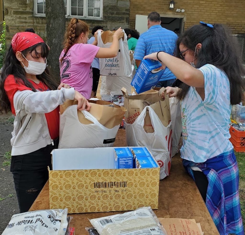 photo of students packing bags of food for the hungry