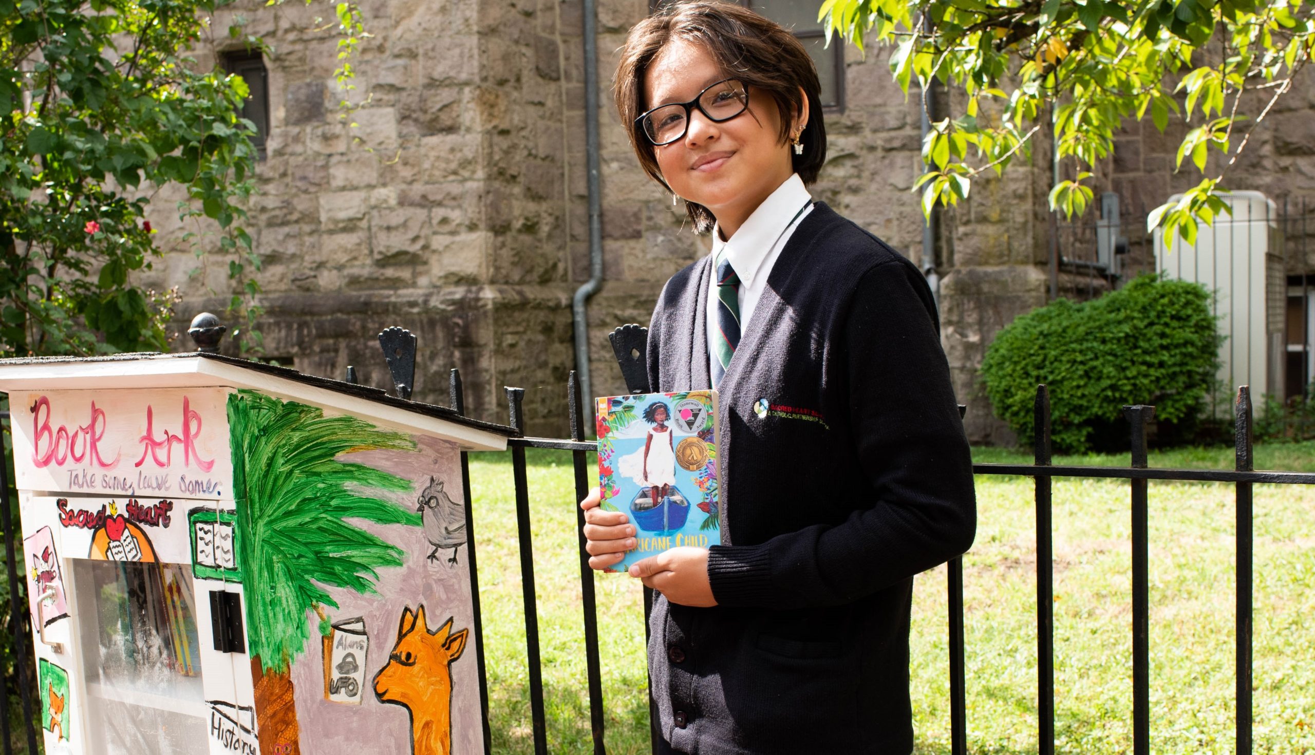 Student from Catholic Partnership Schools with the book ark she codesigned