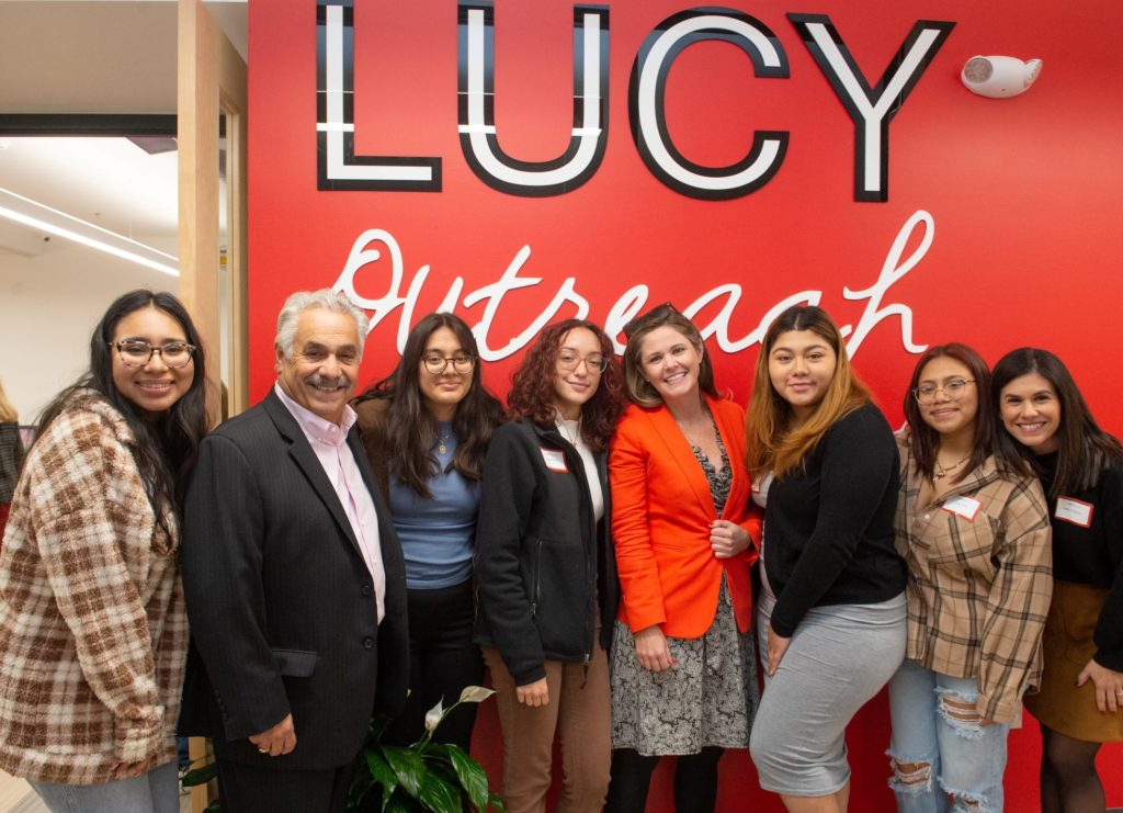 photo of Pipernos and others in front of LUCY sign