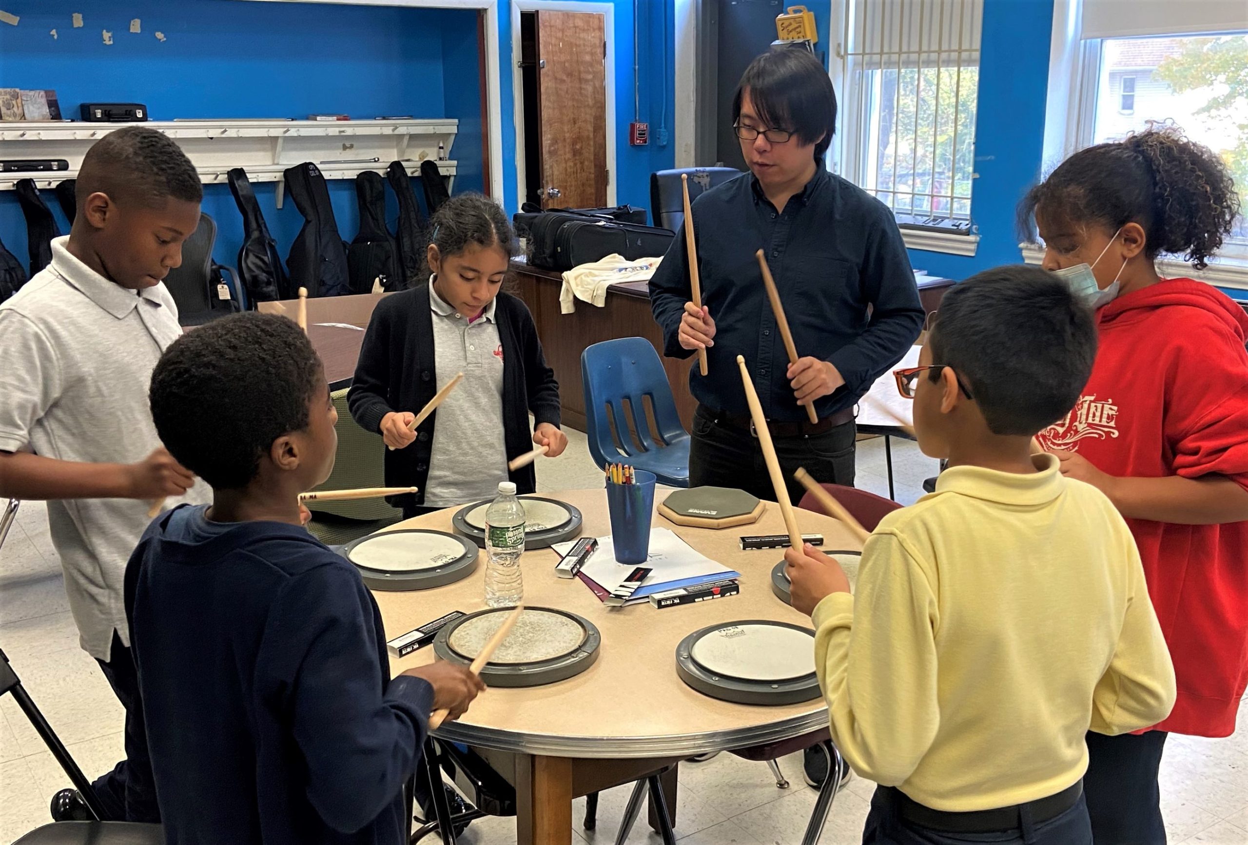 photo of middle school students practicing drums
