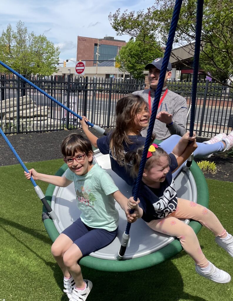 photo of children having fun on a swing