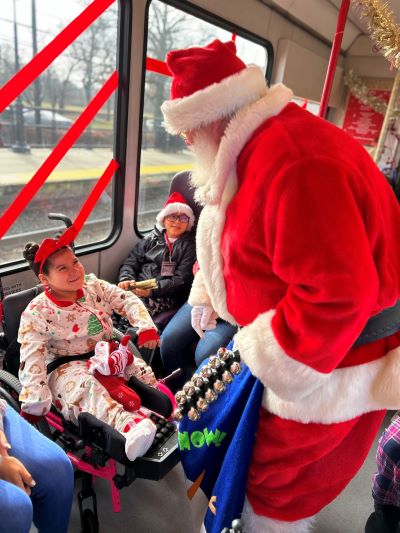Child on train smiling at Santa Claus