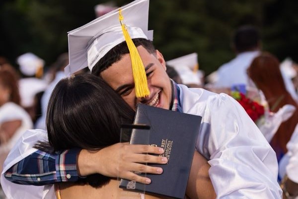 high school graduate hugging his mom