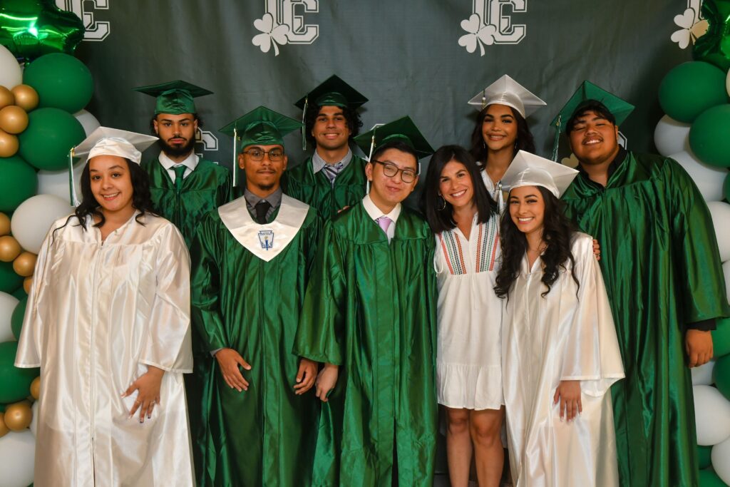 High school grads in cap & gown with Elena Piperno