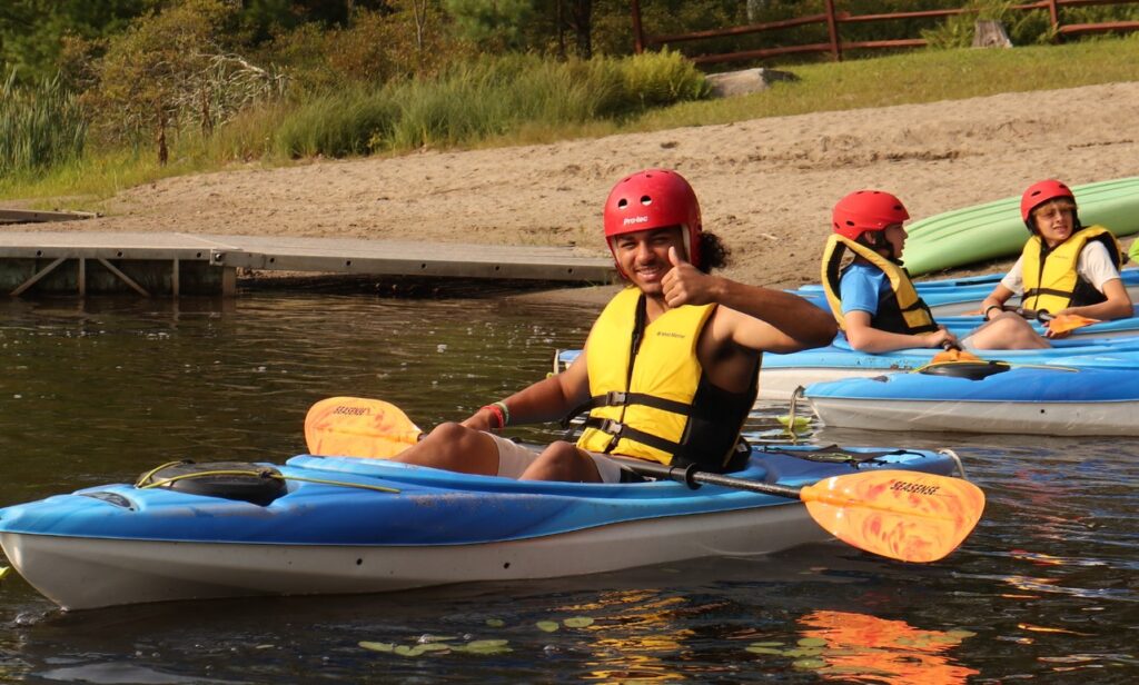 Teen kayaker giving thumbs up