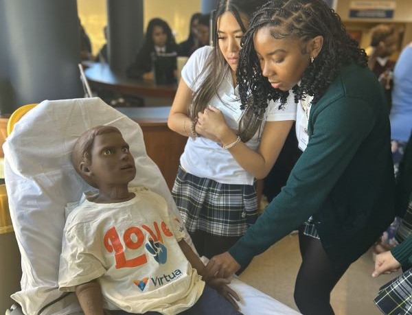 photo of two high school girls with a simulated patient