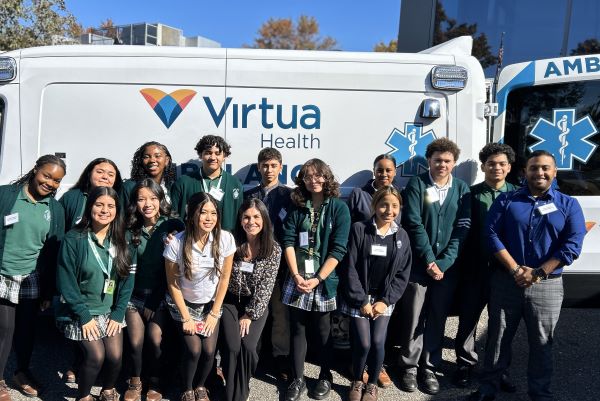 high school student group posed by an ambulance